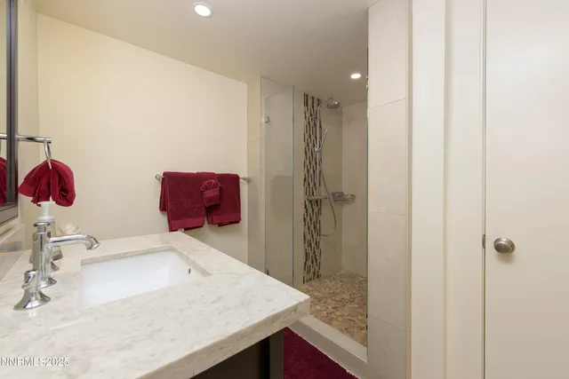 a bathroom with a sink vanity and mirror