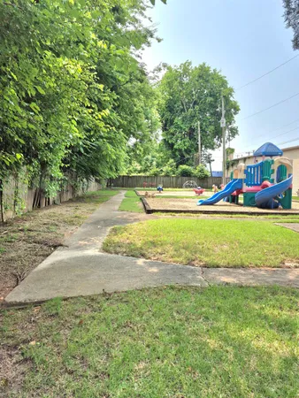 a view of yard with swimming pool and green space