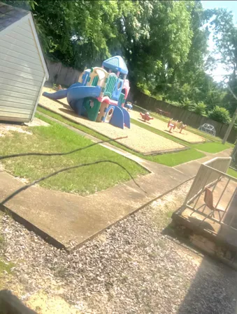a backyard of a house with table and chairs