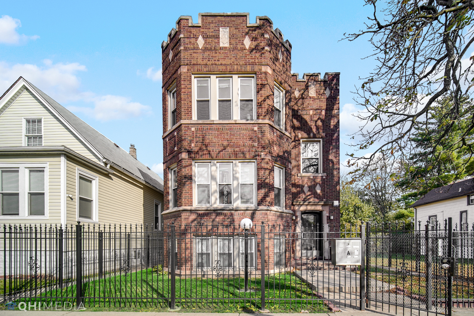 52 West 112th Street Chicago, IL 60628 - Photo 2 of 28 a front view of a building with a garden