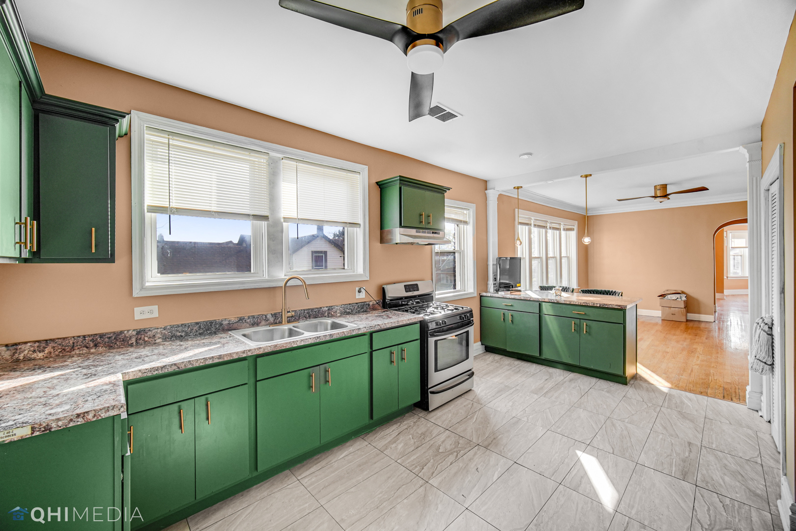 52 West 112th Street Chicago, IL 60628 - Photo 22 of 28 a kitchen with a sink and wooden cabinets