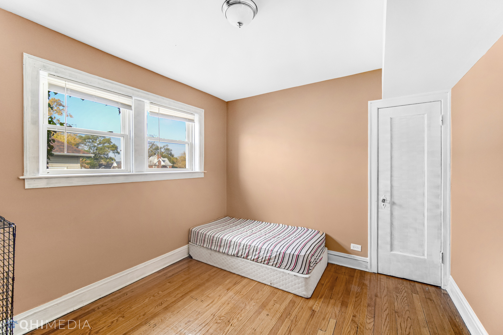 52 West 112th Street Chicago, IL 60628 - Photo 23 of 28 a bedroom with a bed and wooden floor