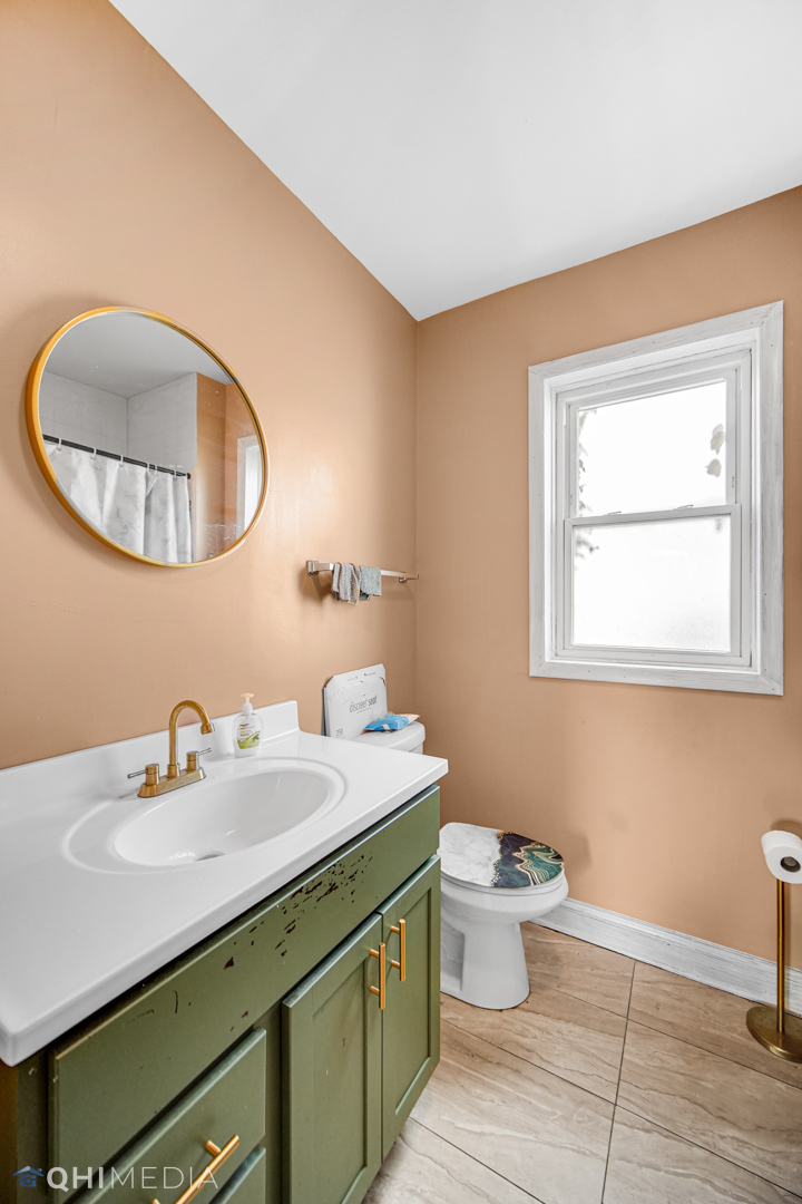 52 West 112th Street Chicago, IL 60628 - Photo 24 of 28 a bathroom with a sink and a mirror