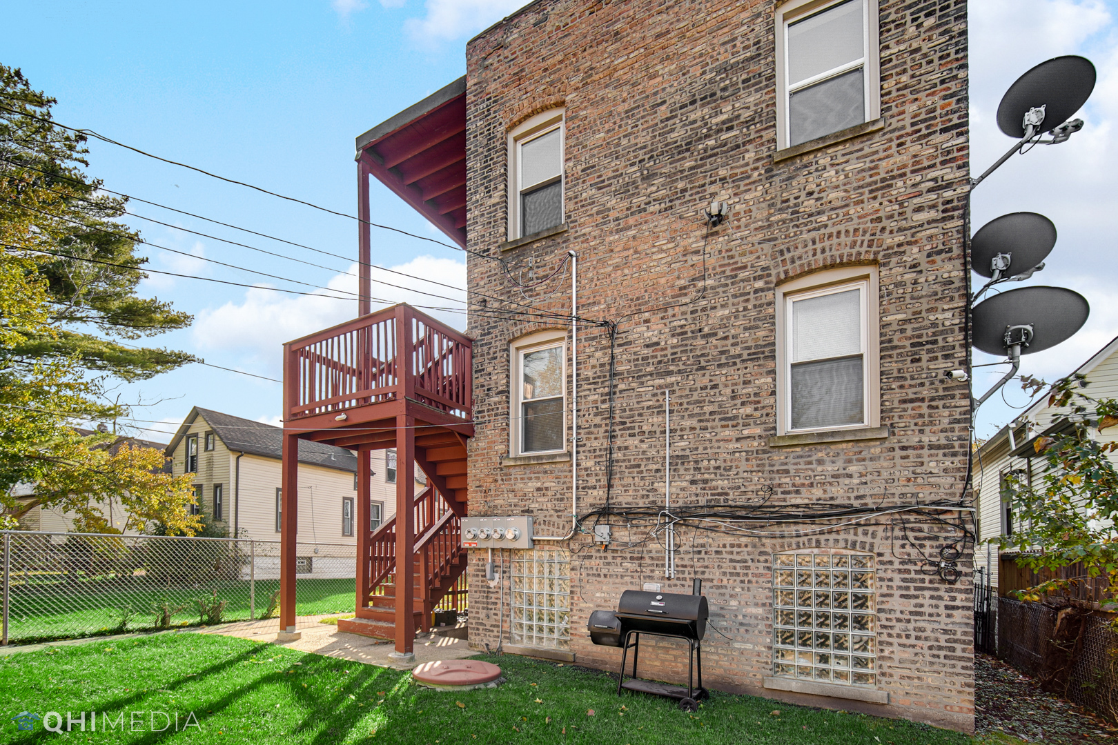 52 West 112th Street Chicago, IL 60628 - Photo 27 of 28 a brick building with a bench and a yard