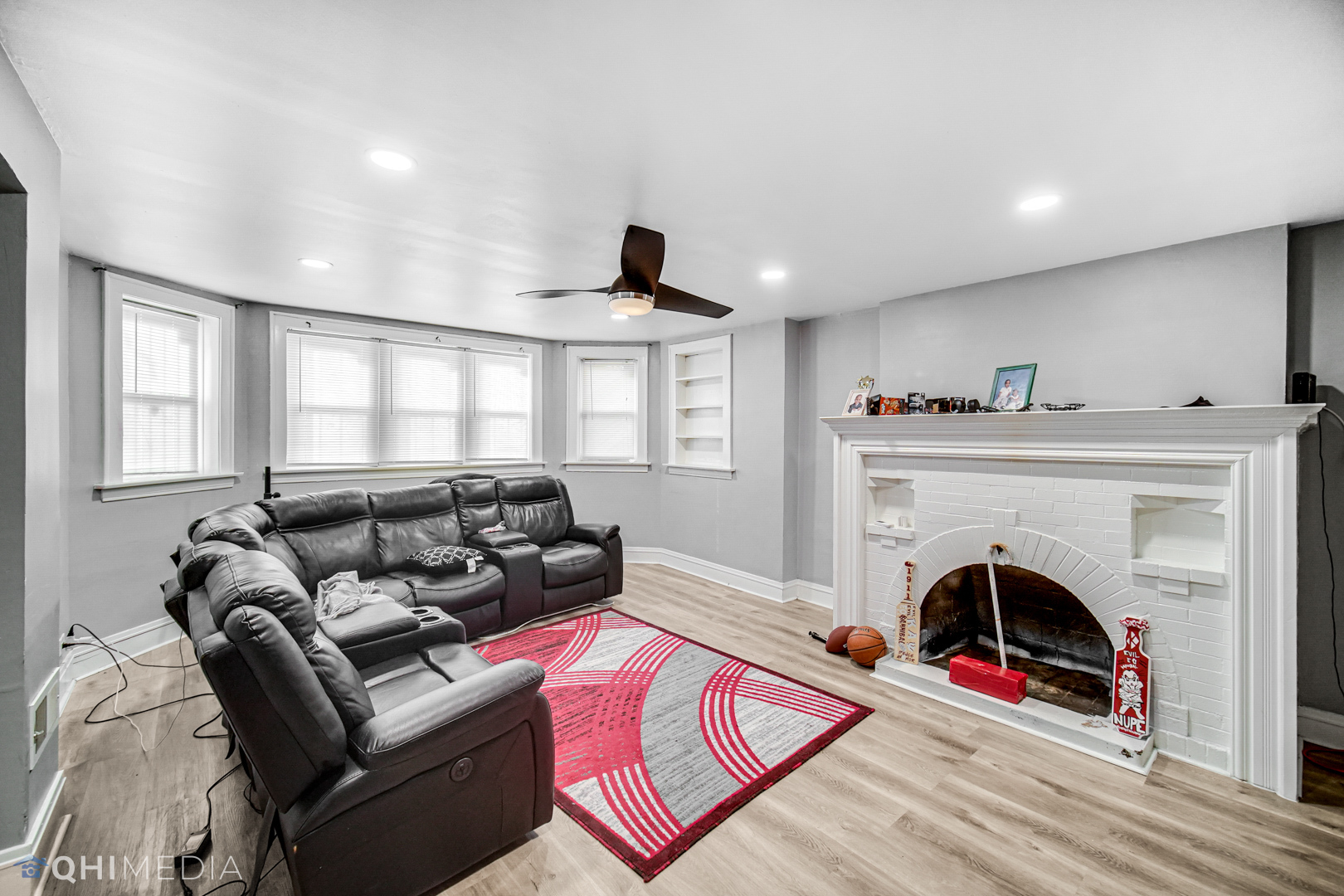 52 West 112th Street Chicago, IL 60628 - Photo 4 of 28 a living room with furniture a fireplace and a flat screen tv