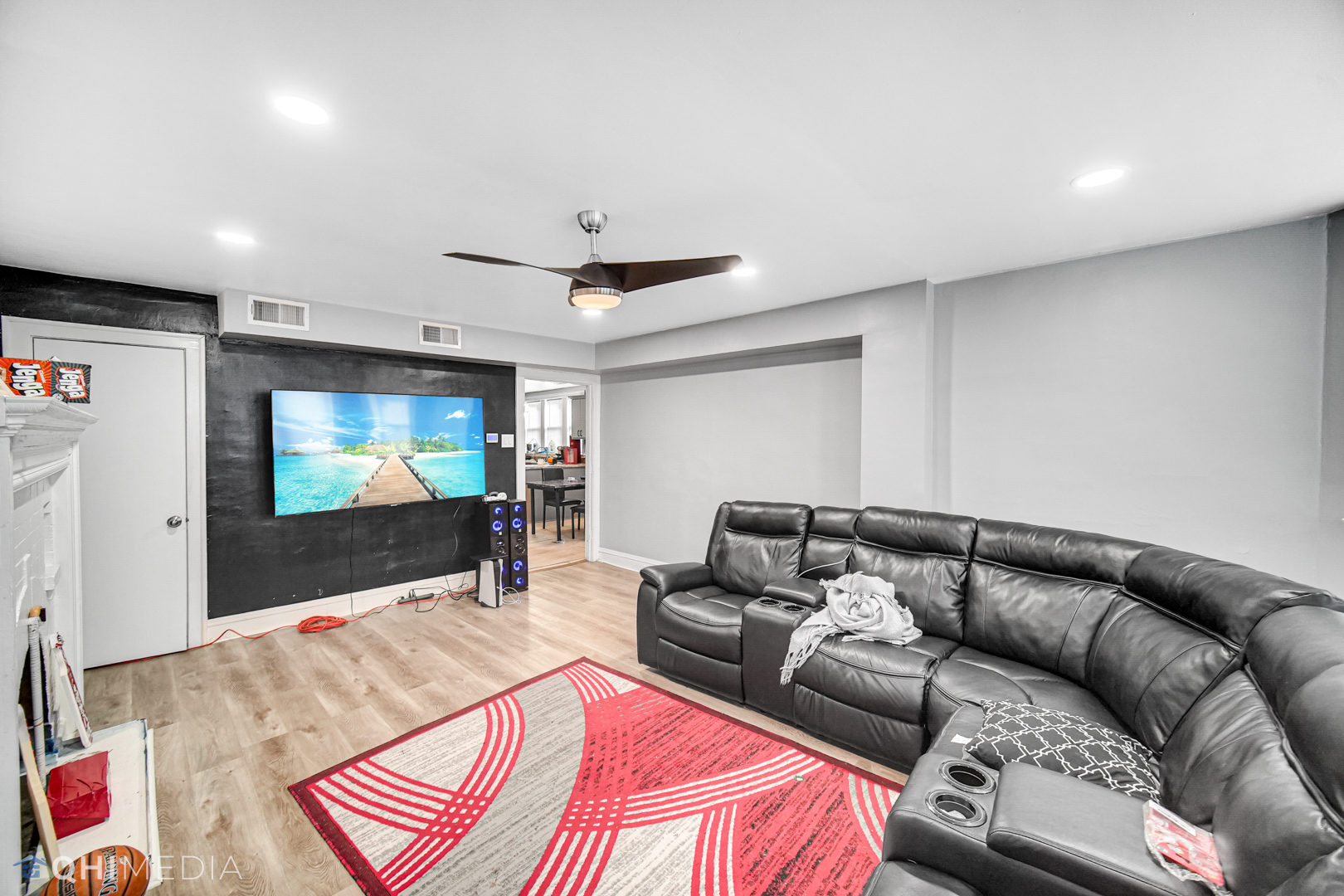 52 West 112th Street Chicago, IL 60628 - Photo 5 of 28 a living room with furniture and a flat screen tv