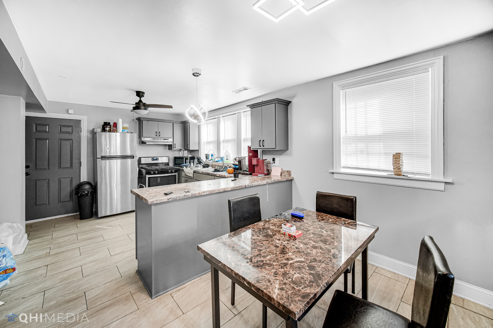 52 West 112th Street Chicago, IL 60628 - Photo 6 of 28 a kitchen with a table and refrigerator in it