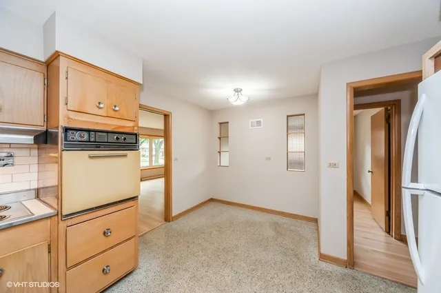 a view of a kitchen with refrigerator and cabinet