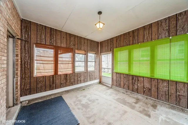 a view of an empty room with a window and a balcony