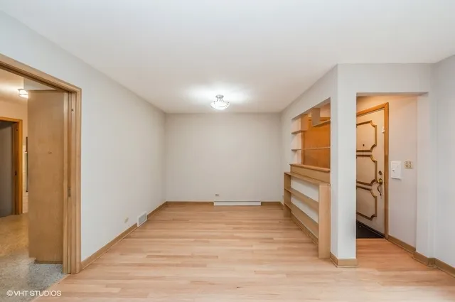 a view of a room with wooden floor and electronic appliances
