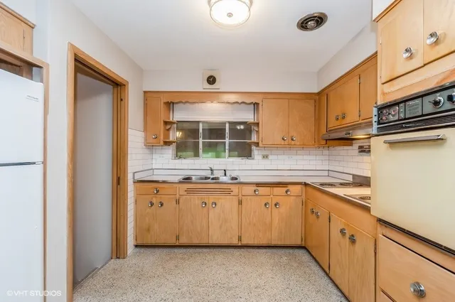 a kitchen with granite countertop a sink stainless steel appliances and cabinets