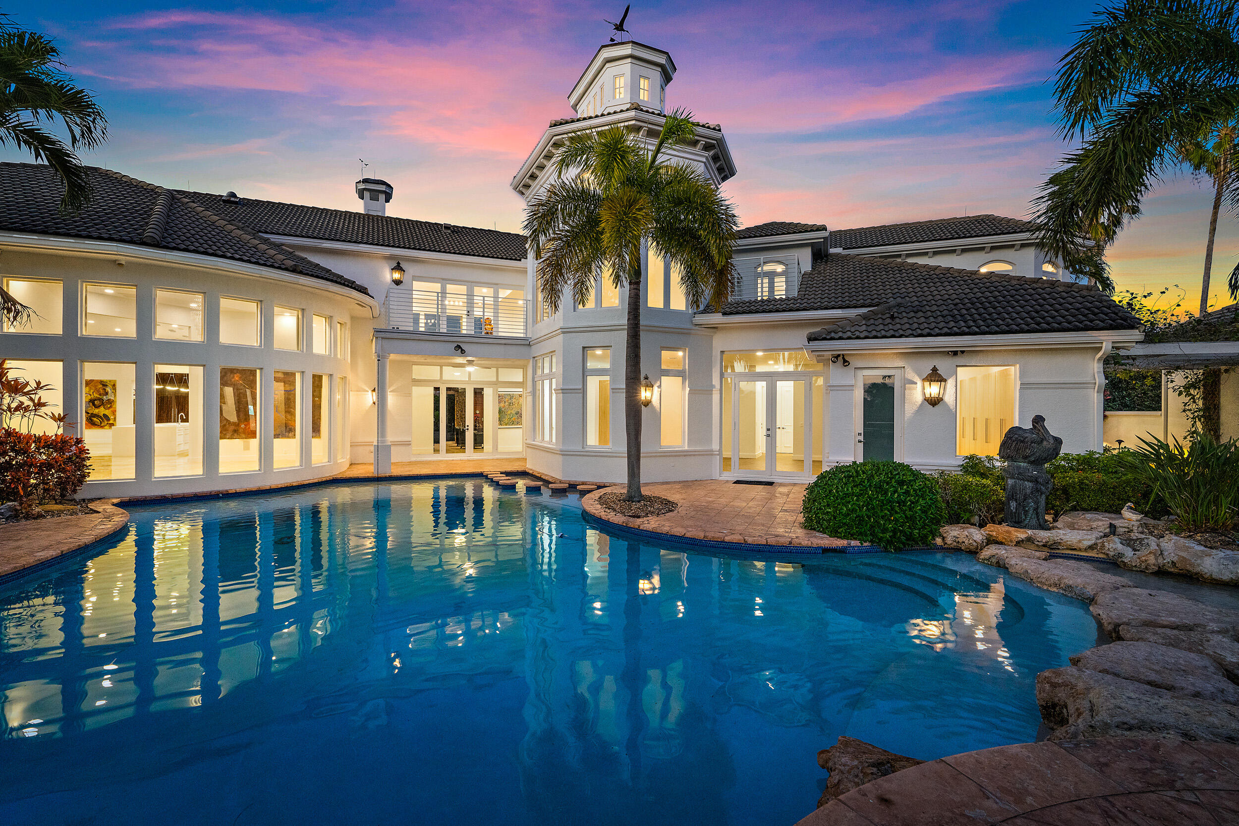 a front view of a house with yard swimming pool and outdoor seating