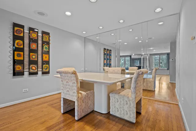 a dining room with furniture and wooden floor