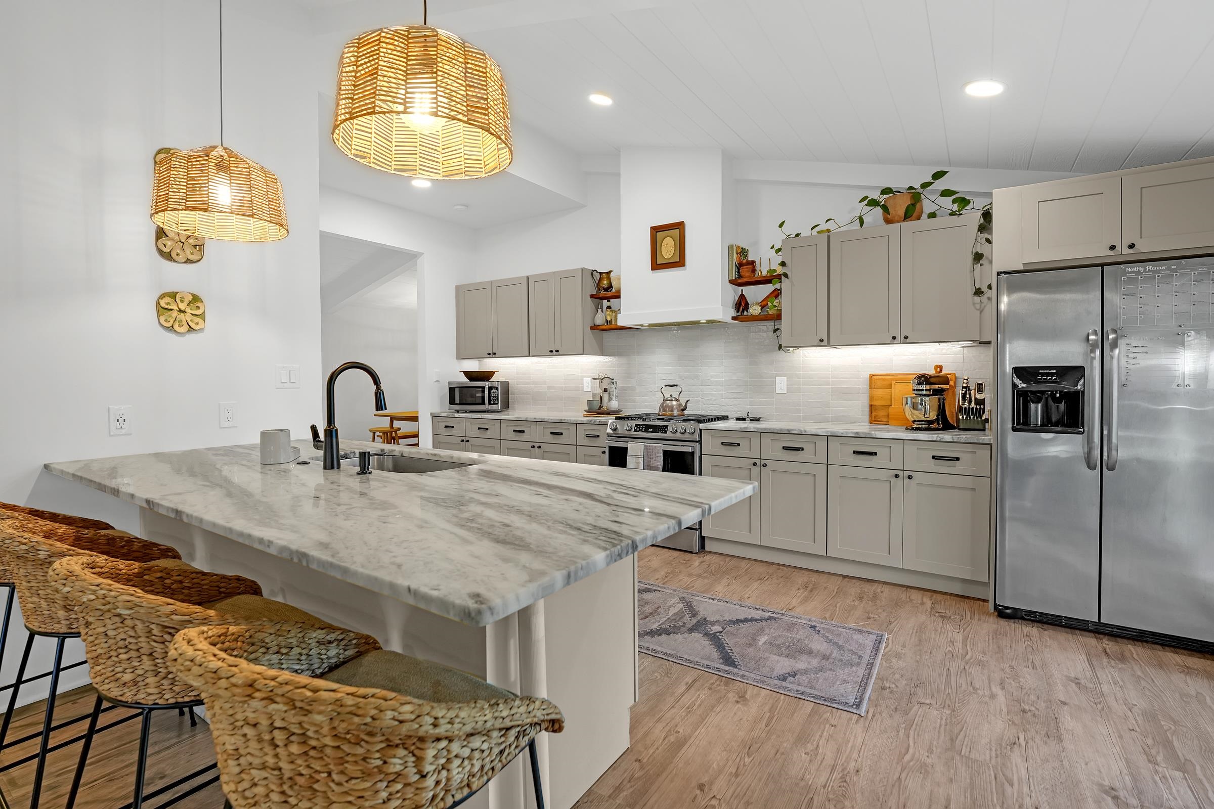 a kitchen with granite countertop a sink appliances and cabinets