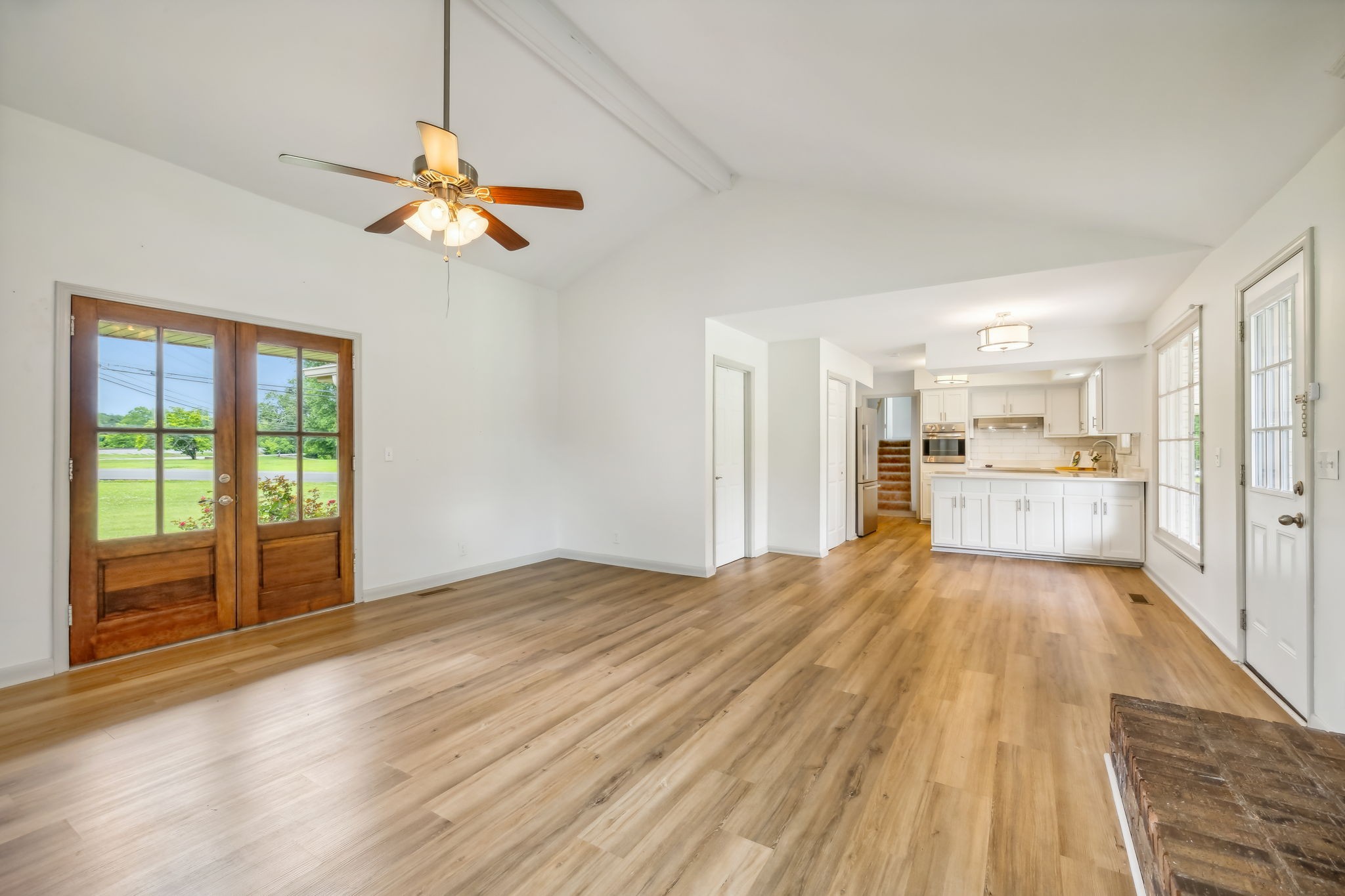 102 Pascal Drive Mount Juliet, TN 37122 - Photo 3 of 41 a view of a kitchen with wooden floor a ceiling fan and windows