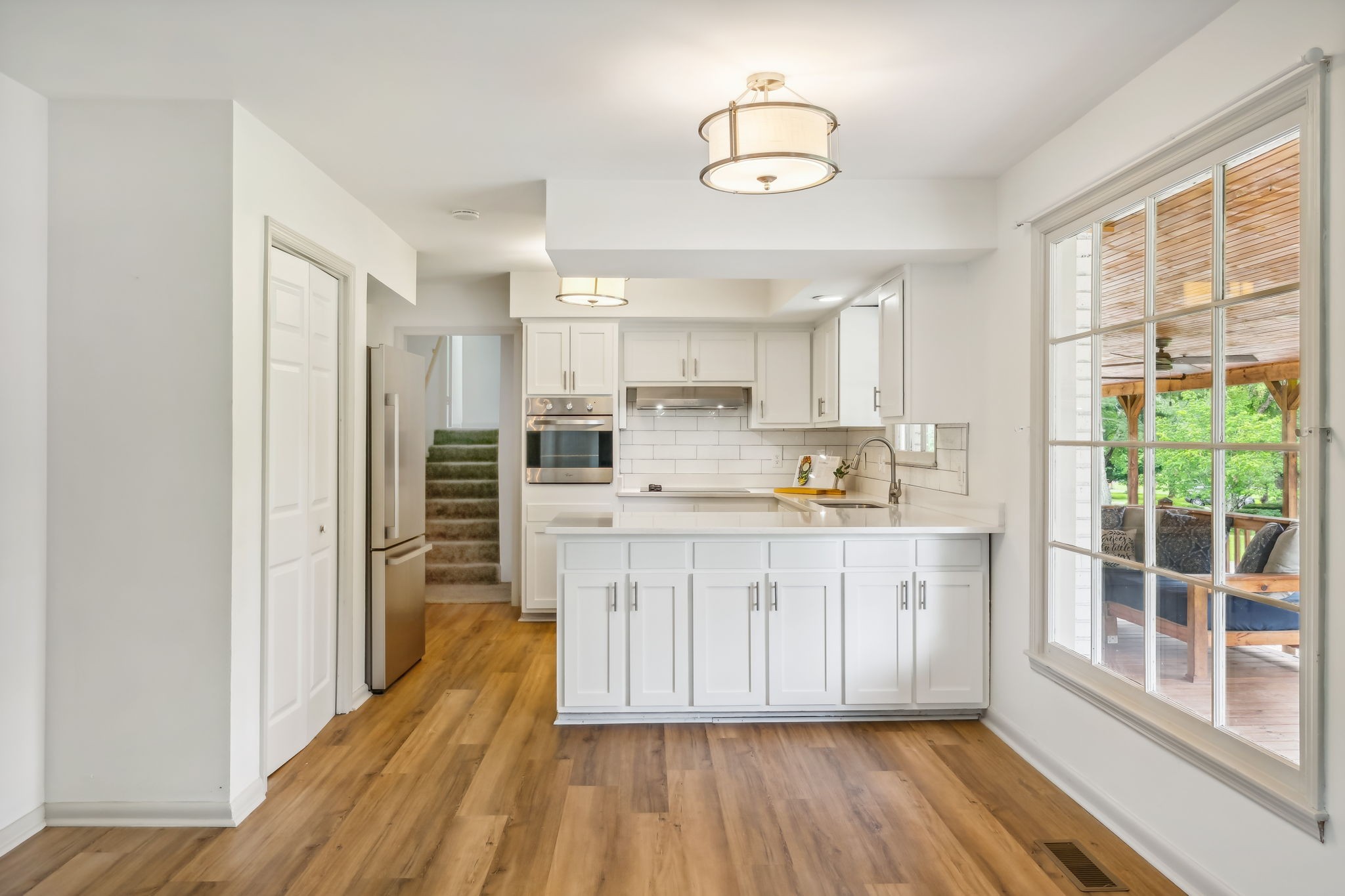 102 Pascal Drive Mount Juliet, TN 37122 - Photo 6 of 41 a kitchen with granite countertop a refrigerator a stove a sink and dishwasher with wooden floor