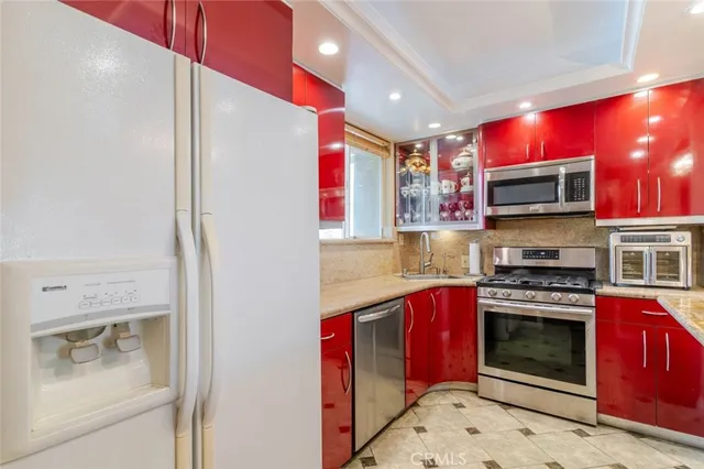 a bathroom with a granite countertop sink a toilet and mirror