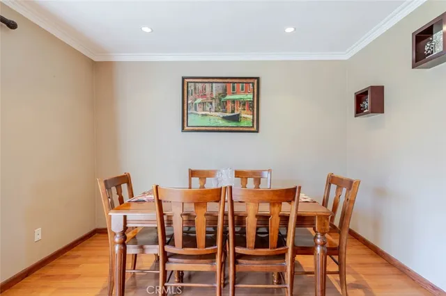 a dining room with furniture and wooden floor