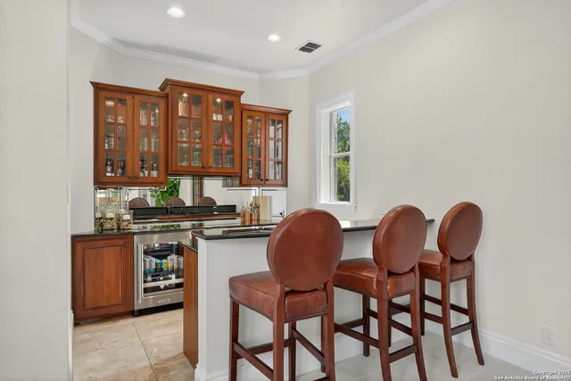a kitchen with a stove and a wooden floor