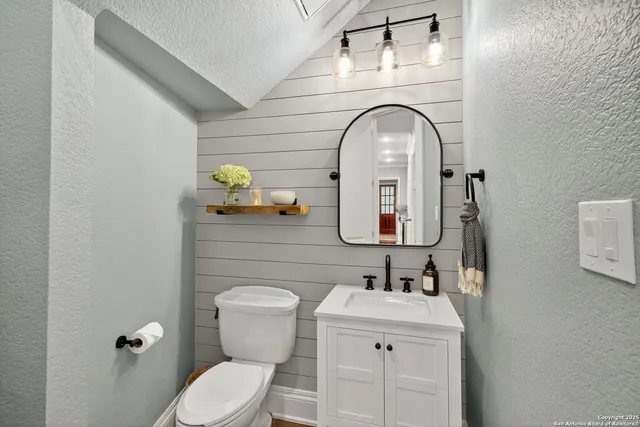 a spacious bedroom with a bed a table and chairs