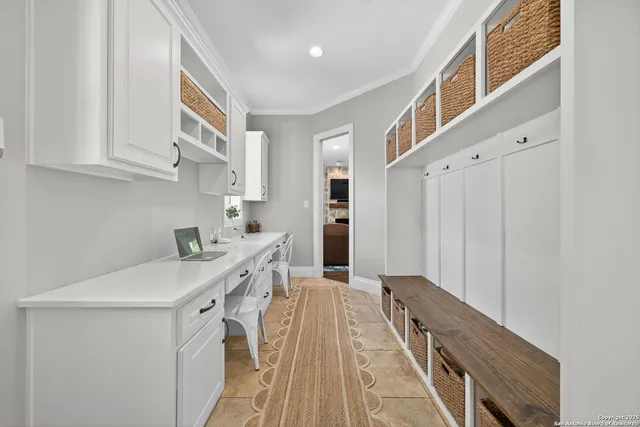 a white bed sitting in a bedroom next to a window