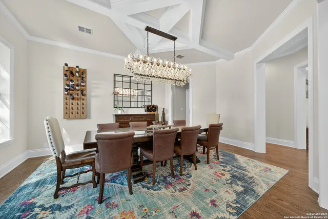a living room with furniture rug and wooden floor