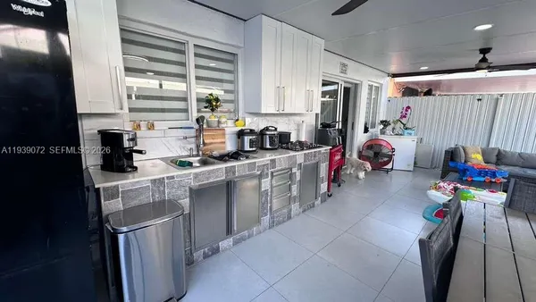 a kitchen with stainless steel appliances granite countertop a sink dishwasher stove and refrigerator