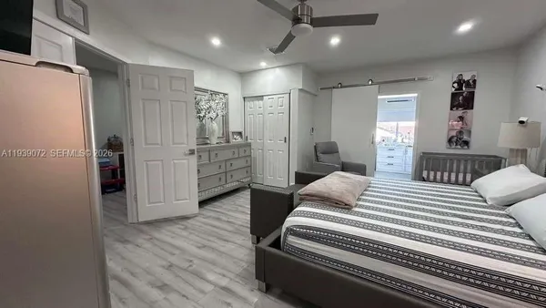 a bedroom with bed and wooden floors