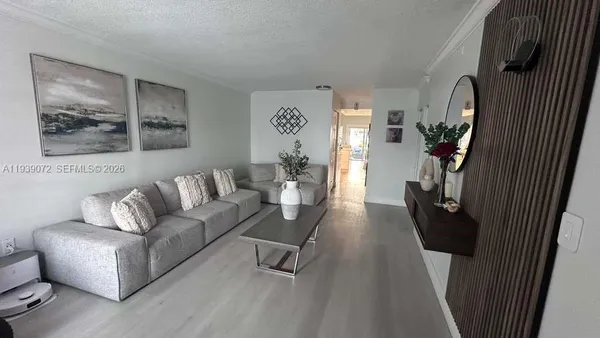 a living room with furniture and a painting on the wall