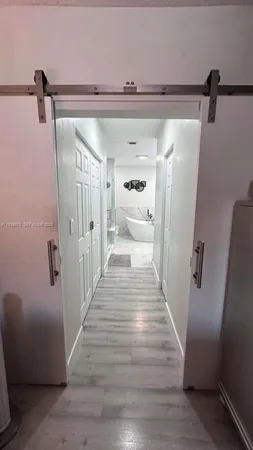 a view of a bathroom from the hallway