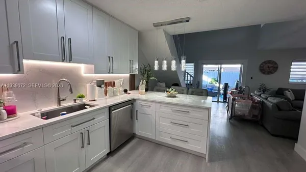 a kitchen with cabinets oven and a sink