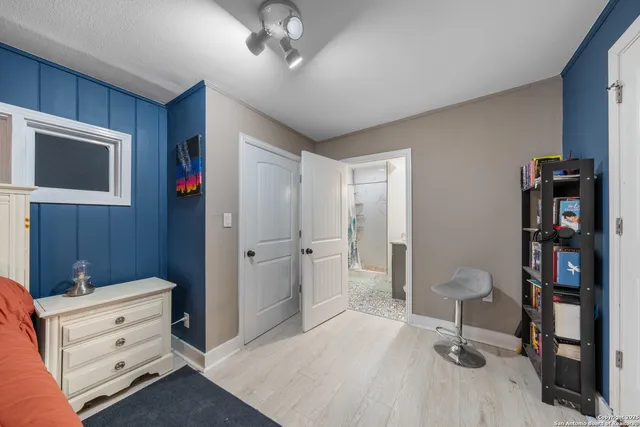 a living room with furniture and a bookshelf