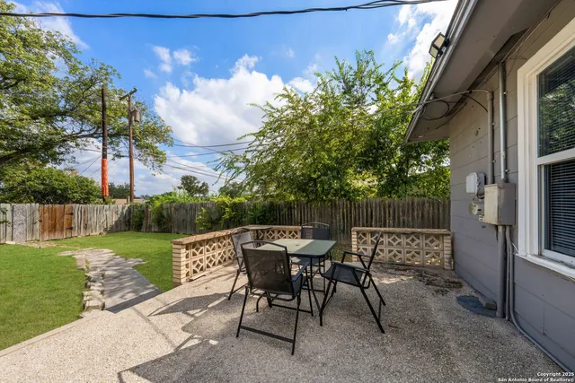 a view of a chairs and table in backyard of the house
