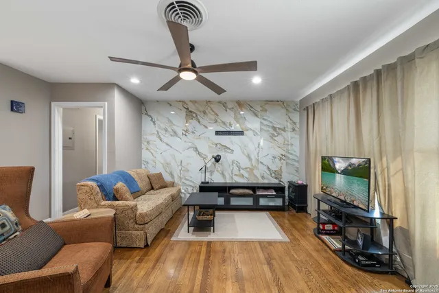 a living room with furniture and a flat screen tv