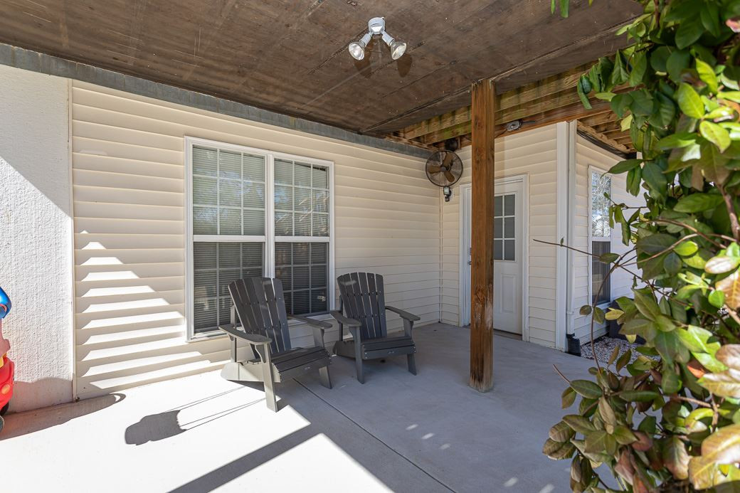8206 Marvino Lane Raleigh, NC 27613 - Photo 25 of 30 Concrete patio sits under the screened porch. Enjoy the outdoors and stay nicely shaded! Patio