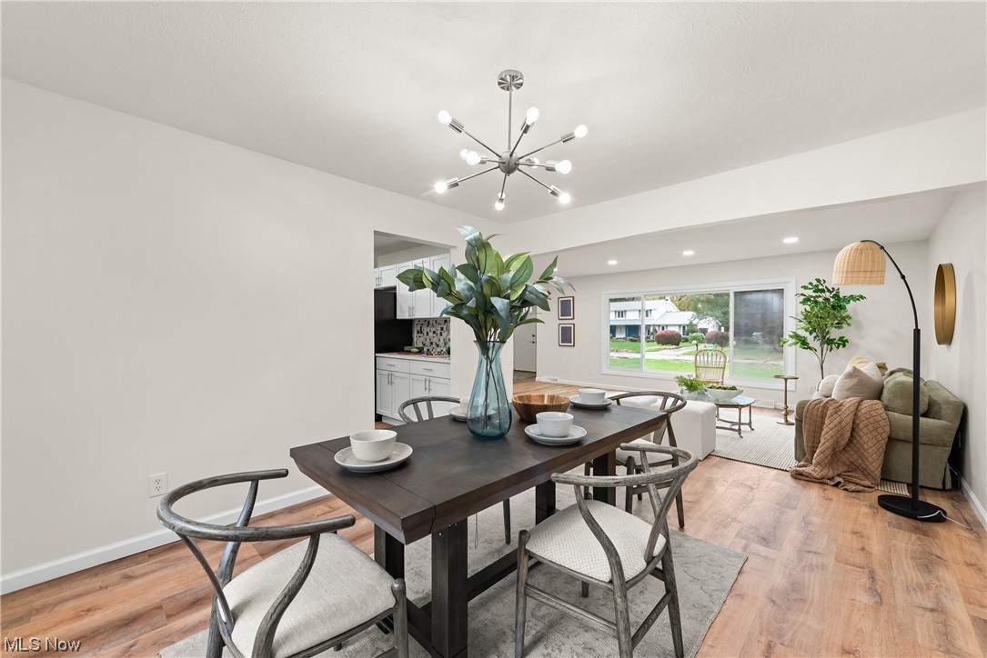 896 Beechers Brook Road Cleveland, OH 44143 - Photo 10 of 35 Dining area featuring an inviting chandelier and light hardwood / wood-style flooring