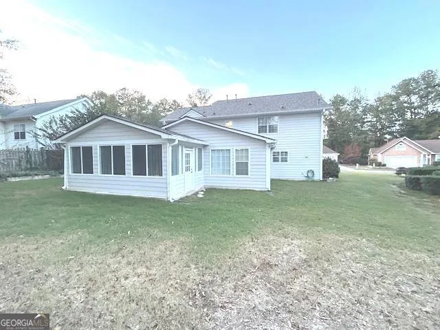 a view of a house with a yard