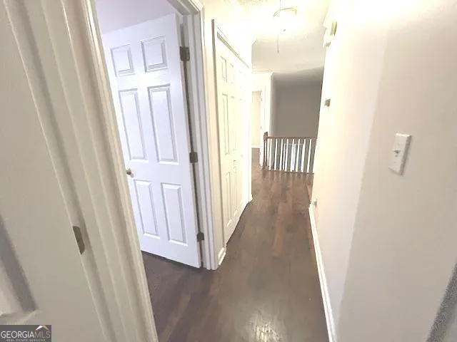 a kitchen with stainless steel appliances granite countertop a refrigerator a sink dishwasher a stove and white countertops with wooden floor