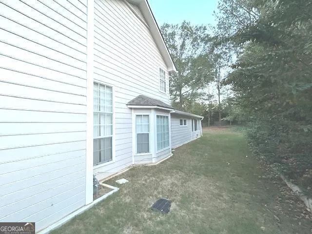 a view of an entryway with wooden floor