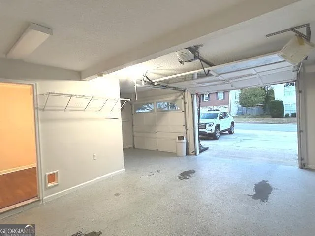 a view of an empty room with wooden floor fireplace and a window