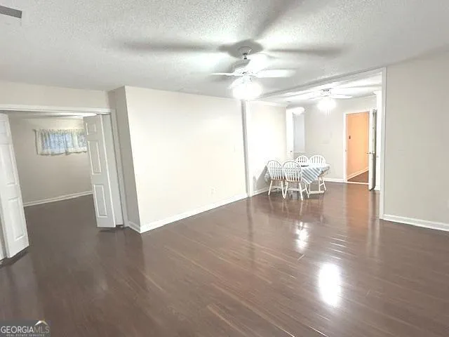 a view of a living room with furniture and floor to ceiling window
