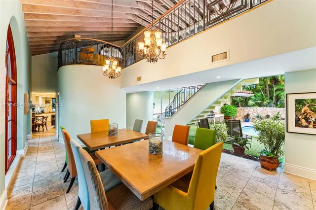 a roof deck with table and chairs and potted plants