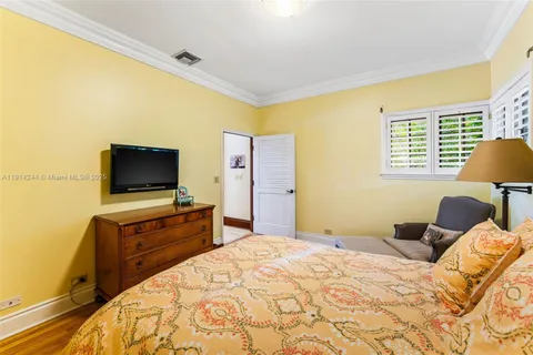 a bedroom with a bed and flat screen tv