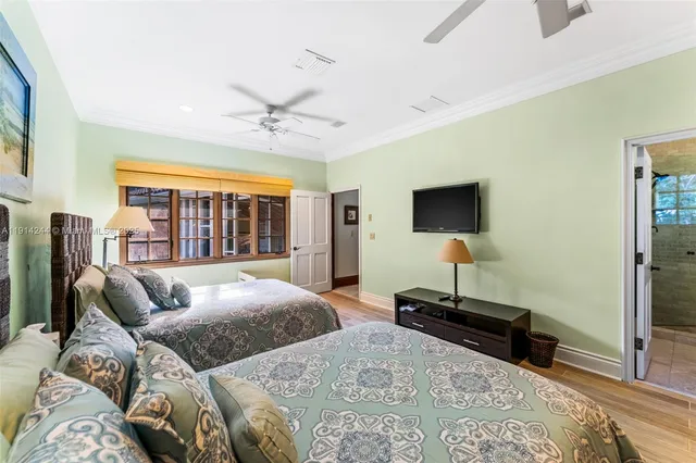 a living room with a bed furniture and a flat screen tv
