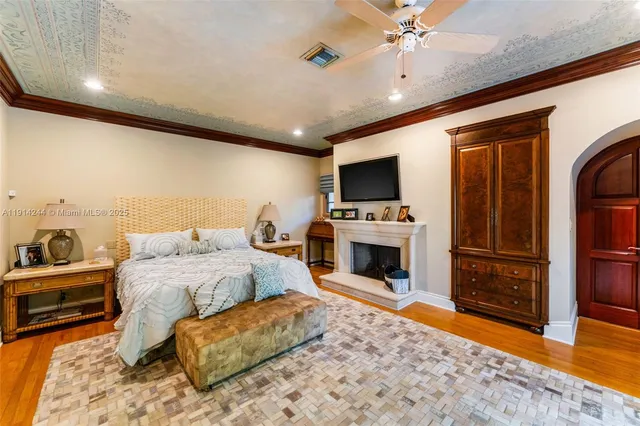 a spacious bedroom with a bed and a television