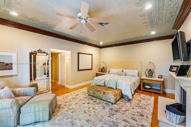 a spacious bedroom with a bed a couch and a flat screen tv