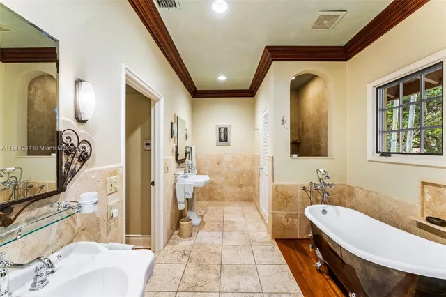 a spacious bathroom with a bathtub shower sink and mirror