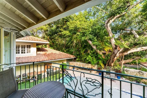 a roof deck with a table and chairs