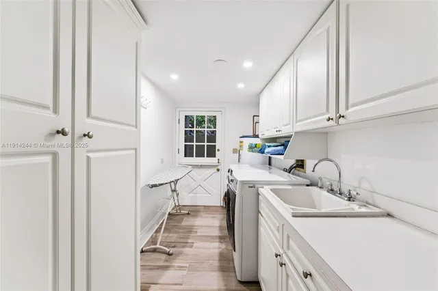 a kitchen with a sink a stove a refrigerator and cabinets