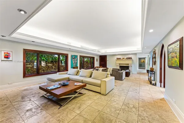 a living room with furniture large window and a table